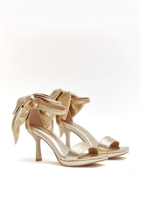 Sandalias doradas de invitada con lazo XL al tobillo